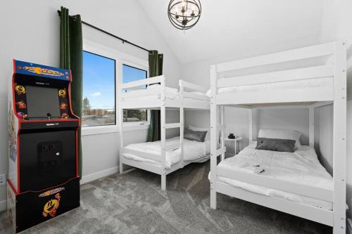 a room with two bunk beds and a video game at Modern Luxury Home - King Bed•Arcade•WEM•A/C in Edmonton