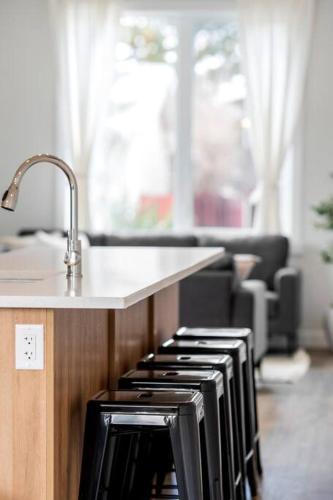 a kitchen with a stove with a counter top at Modern Luxury Home - King Bed•Arcade•WEM•A/C in Edmonton