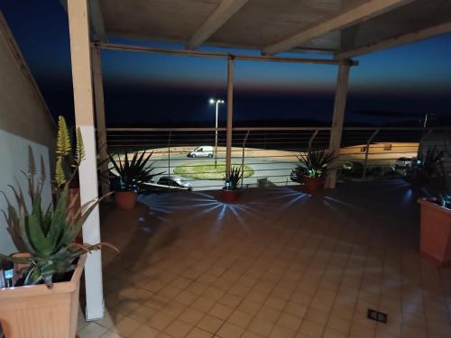 a room with potted plants and a parking lot at ARMAREAOVERSEASSUITES 1 in Fiumicino