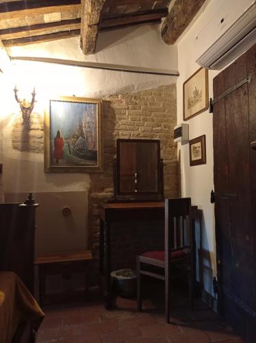 a room with a chair and a tv on a wall at Tenuta Torre Diana in Mordano
