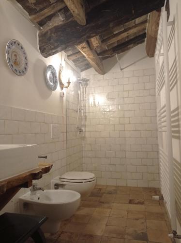 a bathroom with a toilet and a sink at Tenuta Torre Diana in Mordano