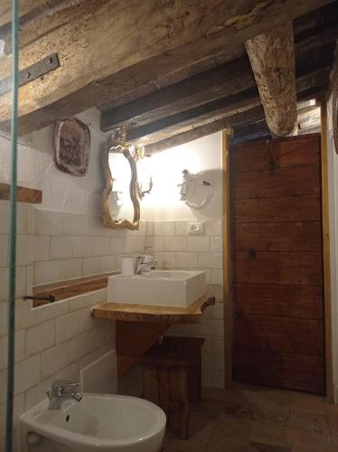 a bathroom with a sink and a toilet and a mirror at Tenuta Torre Diana in Mordano