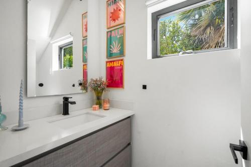 a bathroom with a sink and a window at Scandinavian 2BR, 2Bath Townhome, Pet & Kid Friendly, Free Parking, 10min to Venice Beach! in Los Angeles