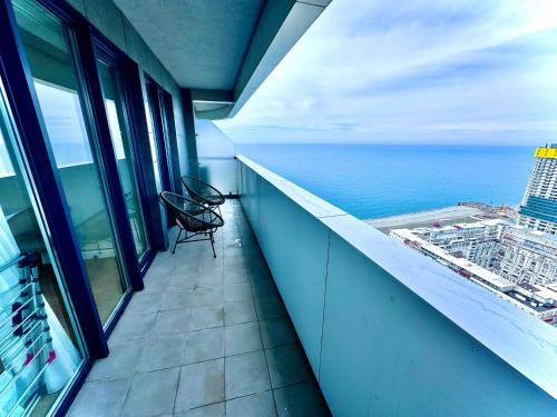 a balcony of a building with a view of the ocean at My Sunshine Apartments in Batumi in Batumi