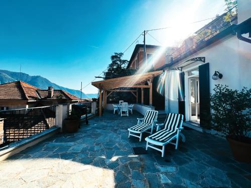 a patio with two chairs on a house at Terrace Lake View Moltrasio in Moltrasio