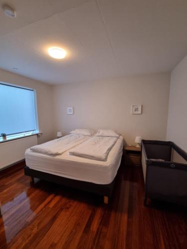 a small bedroom with a bed and a window at Iceland-Aurora in Laugaras