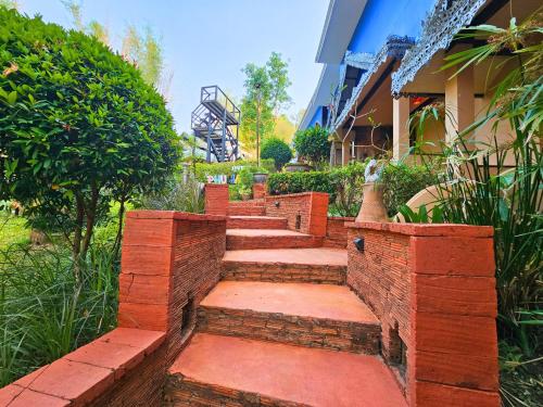a set of brick steps in front of a building at Phu Jaya Floresta Resort by ALPHATEL in Chiang Mai