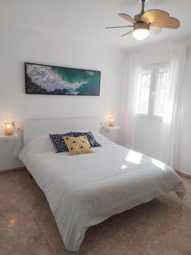 a bedroom with a large white bed with two pillows at #SienteELSUR in Barbate