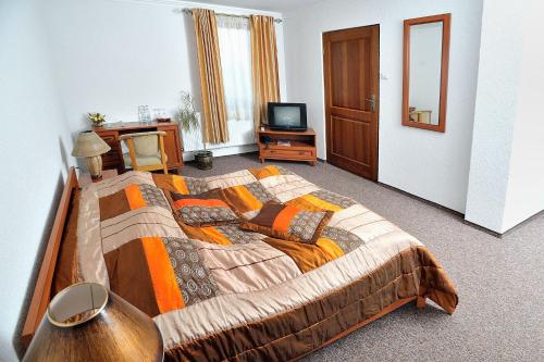 a bedroom with a large bed and a television at Hotel Restauracja Twist in Krosno