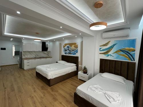 een slaapkamer met 2 bedden en een keuken. bij Bamisa Apartments in Golem