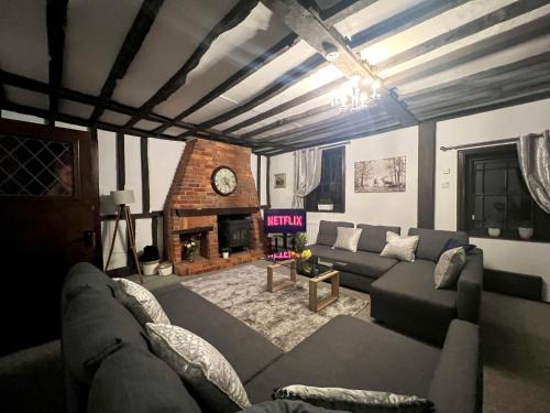 a living room with a couch and a fireplace at Duchess Apartments Modern 3Bedroom Apartment in Colchester Ideal for Long Stays, Relocations, Contractors, Secure Parking, WIFI in Colchester