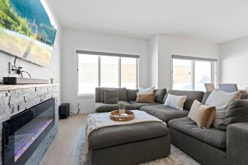 a living room with a couch and a fireplace at Family Home Retreat - 9 mins to WEM - Vintage Arcade-Ping Pong -Air Conditioning in Edmonton