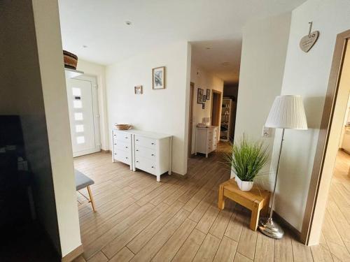 a living room with a desk and a table with a potted plant at Wunderschönes, großes Traumhaus in Lüchow
