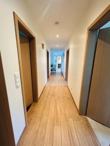 a hallway of an apartment with wooden floors and doors at Wunderschönes, großes Traumhaus in Lüchow