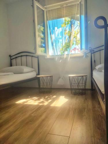 a room with two bunk beds and a window at Holiday Home Bepo in Sevid
