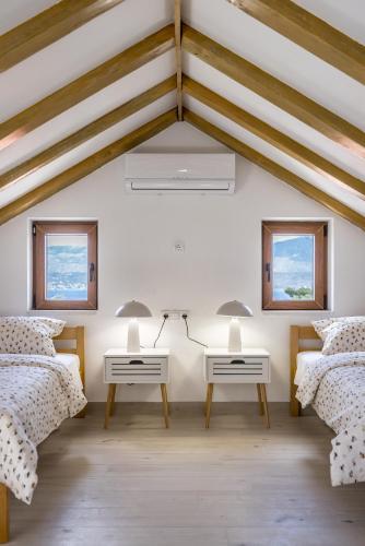 a room with three beds and two tables at Villa Užanca in Splitska