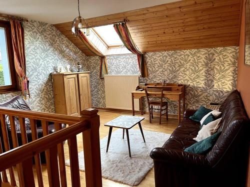 a living room with a couch and a table at La maison de Louise in Bians-les-Usiers