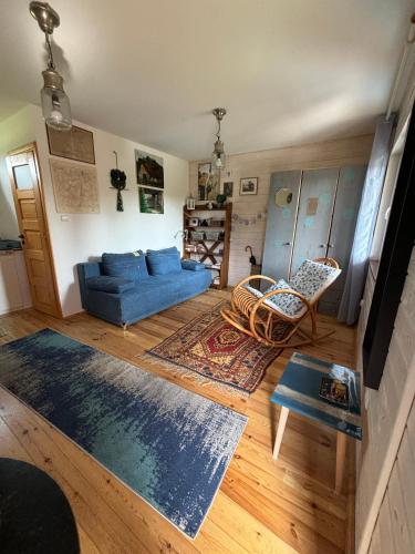 a living room with a blue couch and chairs at Siedlisko Julitkowo in Człopa