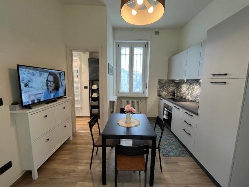 a kitchen with a table and a tv in it at Casa Angioletta in Gassino Torinese