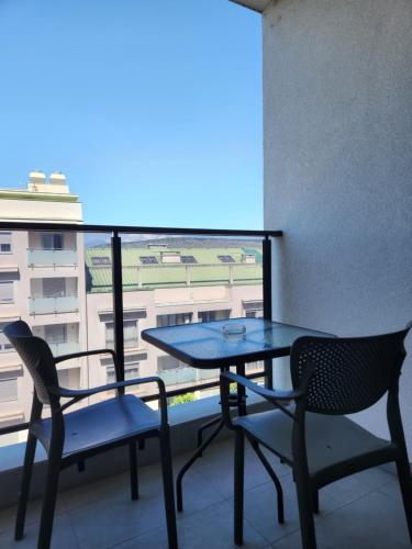a table and chairs on a balcony with a view at Green Apartments Podgorica With Garage in Podgorica