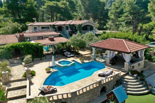 an aerial view of a house with a swimming pool at Villa Stone House Poplat in Vela Luka