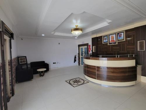 a lobby with a bar in the middle of a room at Admiralty Hotel in Lekki