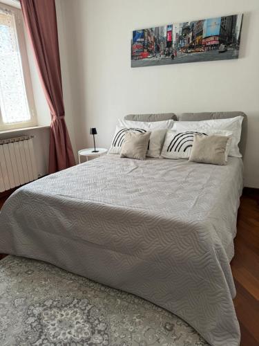 a bedroom with a large bed with two pillows at Rossini apartment in Sassoferrato