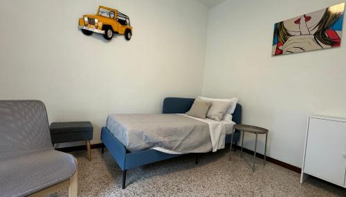 a room with a bed and a toy truck on the wall at Rossini apartment in Sassoferrato