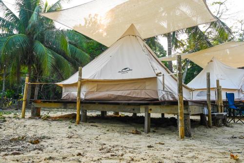 プルフンティアン島にあるLong Beach Campのヤシの木の隣のビーチのテント