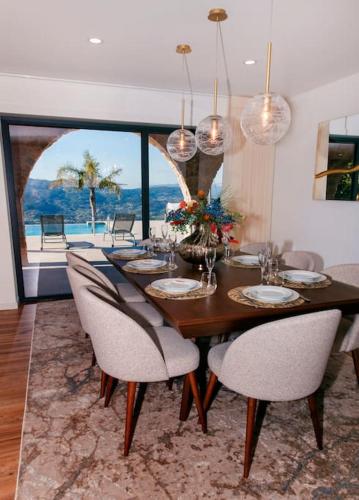 a dining room with a wooden table and chairs at Vista D'Ouro- A luxury villa in the mountains in Ponte da Barca