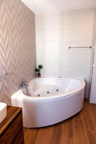 a large white bath tub in a bathroom at Vista D'Ouro- A luxury villa in the mountains in Ponte da Barca