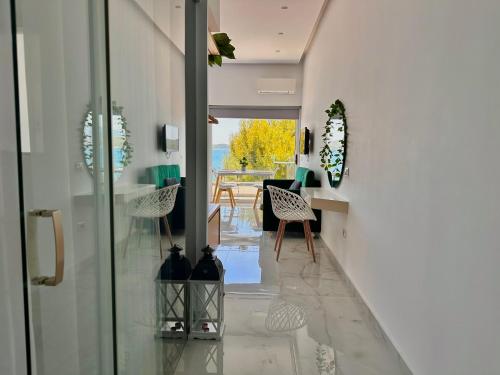 a hallway of a house with a table and chairs at Sea Horizon Vsl Suites & Apartments in Sarandë