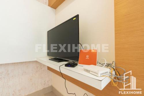 a flat screen tv sitting on top of a white desk at 9am-5pm, SAME DAY CHECK IN AND CHECK OUT, Work From Home, Shaftsbury-Cyberjaya, Comfy Home by Flexihome-MY in Cyberjaya
