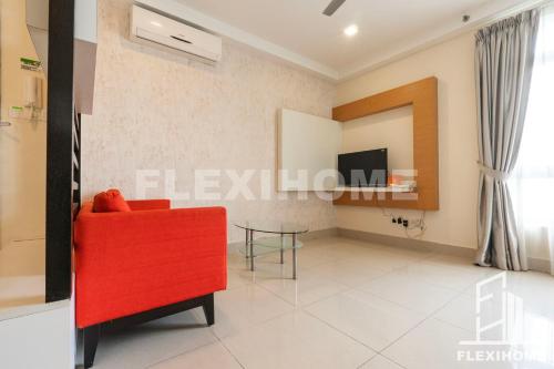 a living room with a red chair and a table at 9am-5pm, SAME DAY CHECK IN AND CHECK OUT, Work From Home, Shaftsbury-Cyberjaya, Comfy Home by Flexihome-MY in Cyberjaya
