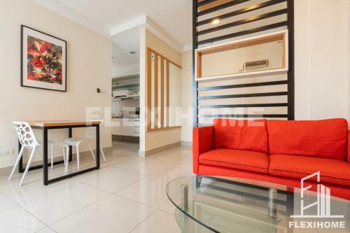 a living room with a red couch and a table at 9am-5pm, SAME DAY CHECK IN AND CHECK OUT, Work From Home, Shaftsbury-Cyberjaya, Comfy Home by Flexihome-MY in Cyberjaya