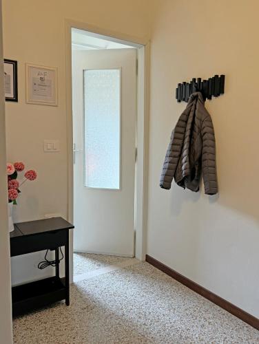 a room with a door and a table and a window at Rossini apartment in Sassoferrato