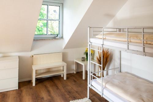 a bedroom with two bunk beds and a desk at Ferienhaus Eisenach in Eisenach
