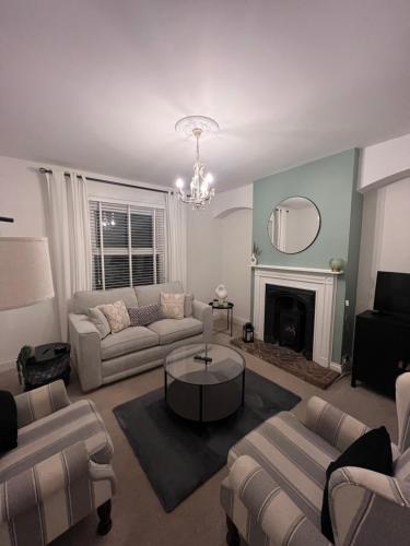 a living room with a couch and a fireplace at Victorian Cottage - The Beach Walmer in Walmer