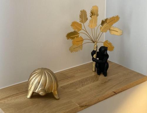 a statue of a tortoise and a plant on a shelf at App-Art in Nice