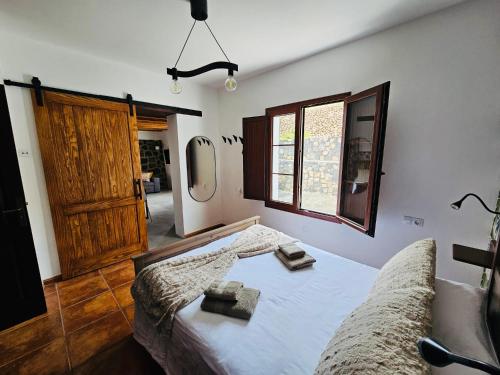 a bedroom with a bed and a wooden door at Casa Celi in Teguise