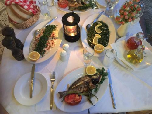 a white table with plates of food on it at Hotel Efes in Gumuldur