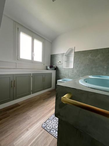 a bathroom with a large tub and a window at Villa de caractère à Saint- Malo 100m du Sillon in Saint Malo