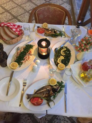 a white table with plates of food on it at Hotel Efes in Gumuldur