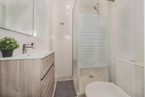 uma casa de banho com um chuveiro, um WC e um lavatório. em Appartement à Paris-Créteil de 20m2 près du métro 8 mn em Créteil