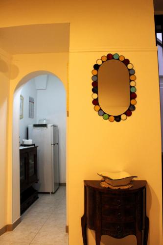 a room with a mirror and a table and a refrigerator at La Terrazza sul Tempio in Brindisi