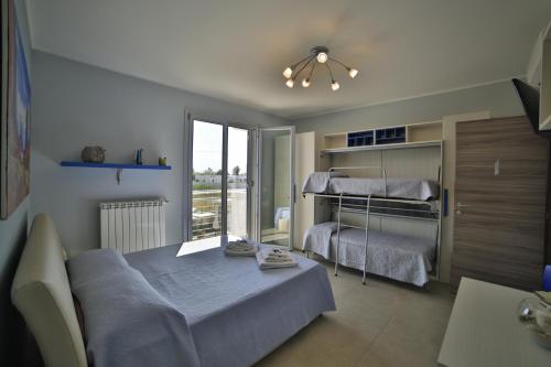 a bedroom with a bed and a bunk bed at A casa di Sofia in Porto Cesareo