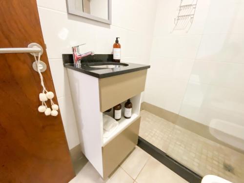 a bathroom with a sink and a shower at Alfa Suites en el casco histórico de Salta in Salta