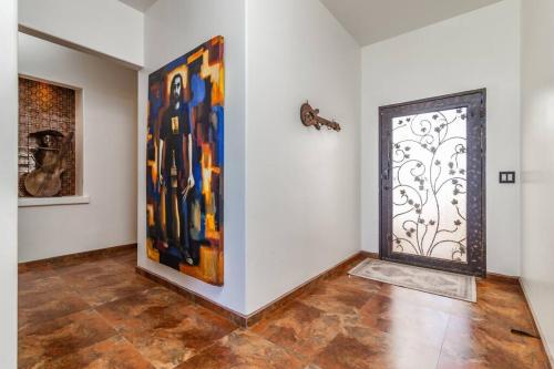a room with paintings on the wall and a door at Oceanfront Home with Private Pool and Hot Tub in La Bloquera