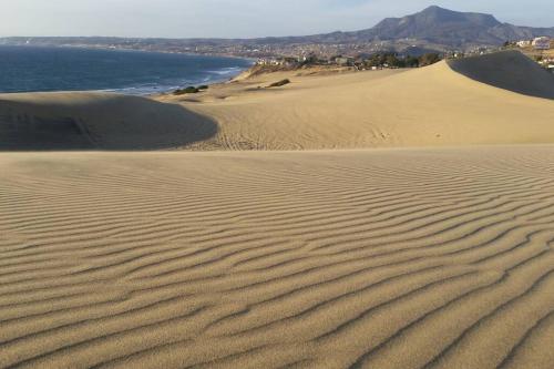 a sand dune with a view of the ocean at Oceanfront Home with Private Pool and Hot Tub in La Bloquera