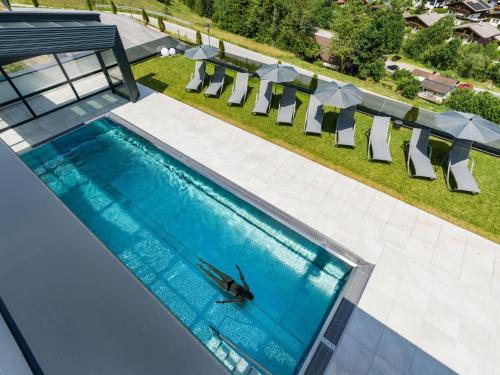 an overhead view of a swimming pool with a person in the water at Sun Valley - Wildschönau in Auffach